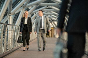 A man and woman having discussion inside contemporary business center on the move
