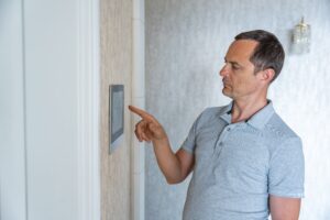 Man using tablet panel application for control smart home living.
